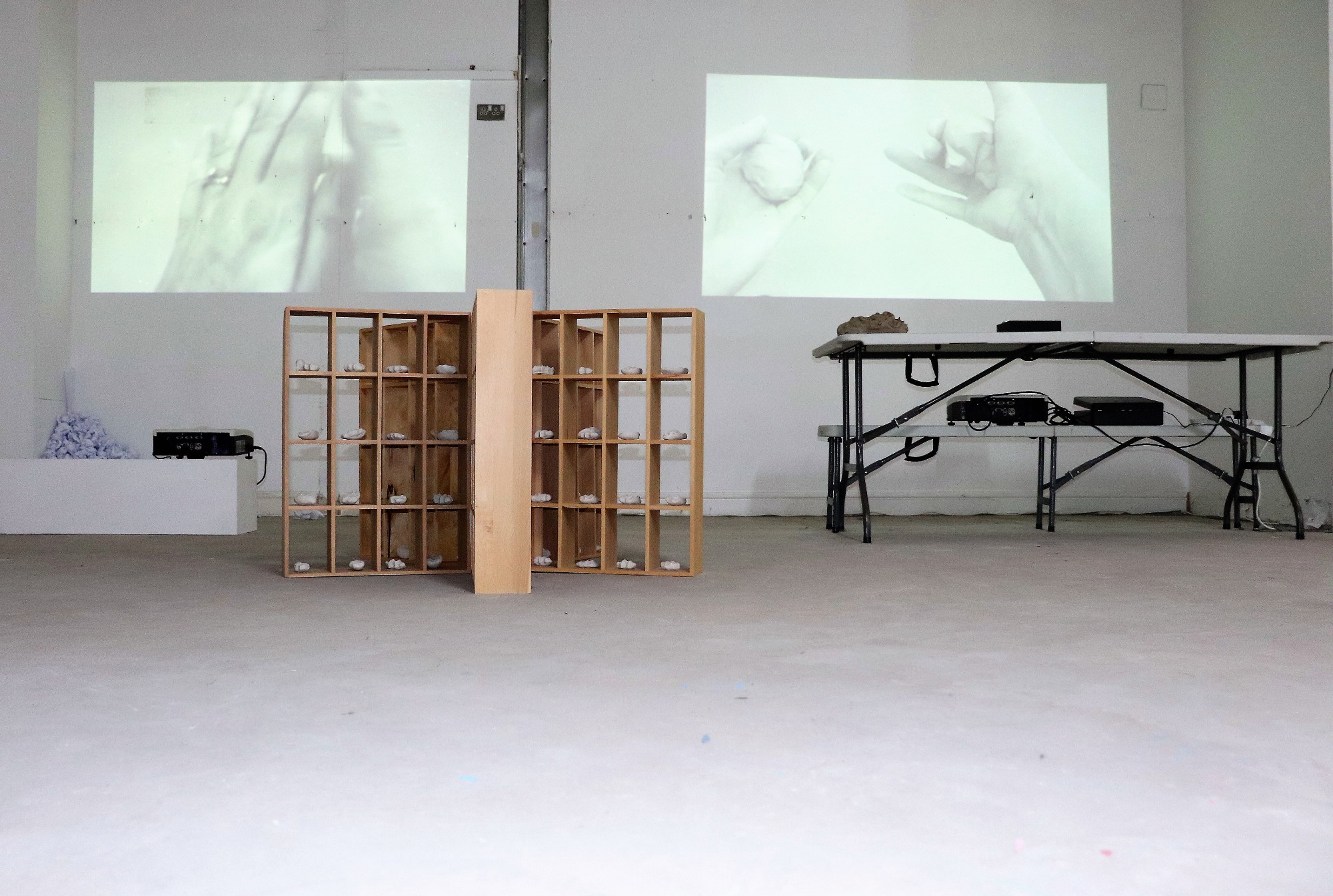 'Holding on' 2019, Installation - Ceramics, paper, clay, video projection, wooden shelving - Sarah Strachan