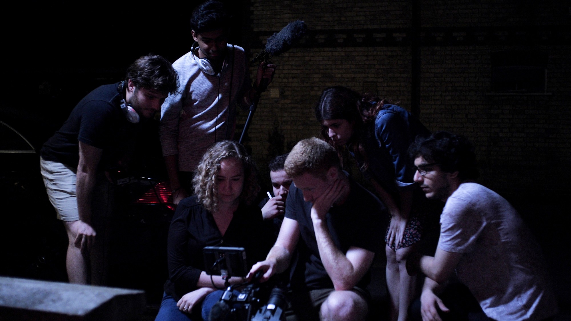 Weronika Tomaszewska, Max Elgar, Francesco Merlini-Fiore, Joana Fonseca and the rest of the crew of 'Relapse' looking at the last take of the film.