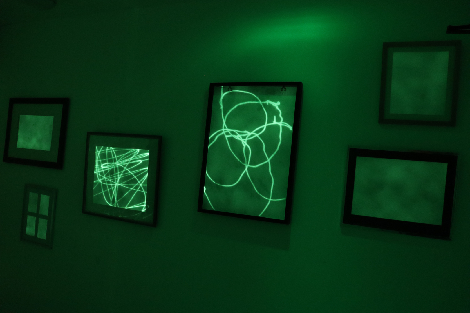Glow in the dark objects in a dark room. Lights and people represented on objects.