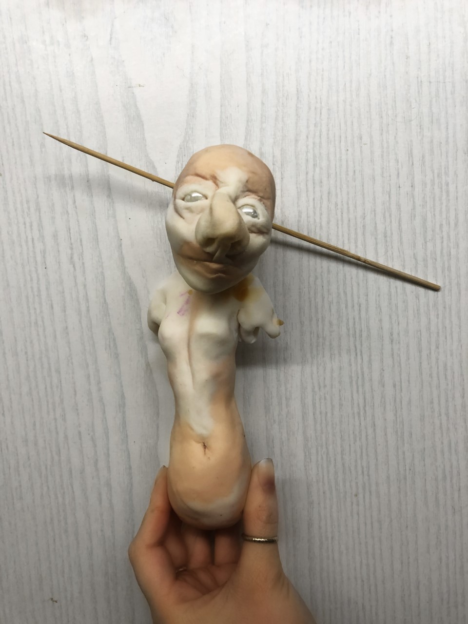 “Shell”. 24cm polymer clay sculpture with wood and marble details representing the dehumanisation you feel as a result of abuse.